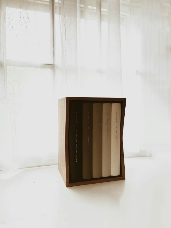 a white and black book shelf with three books on it