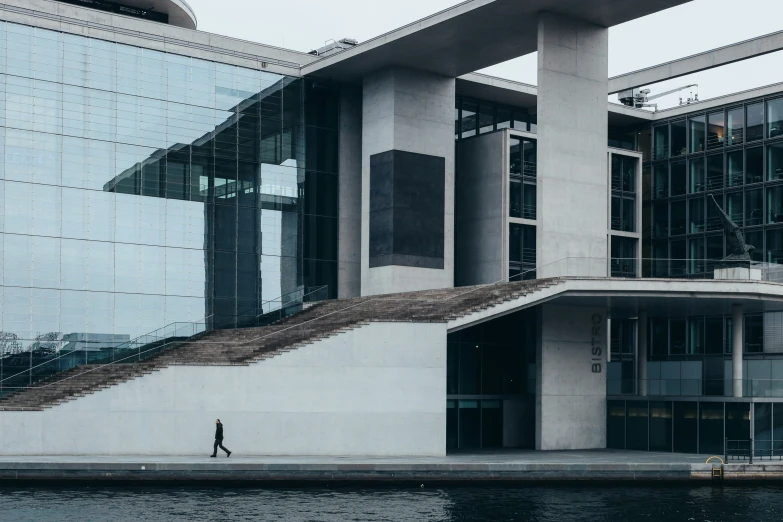 a building with an open air swimming pool near it