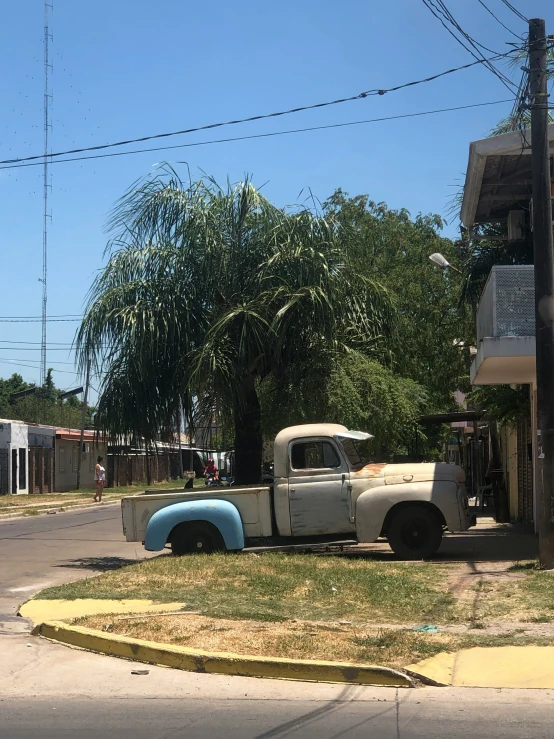 a pickup truck parked on a street corner