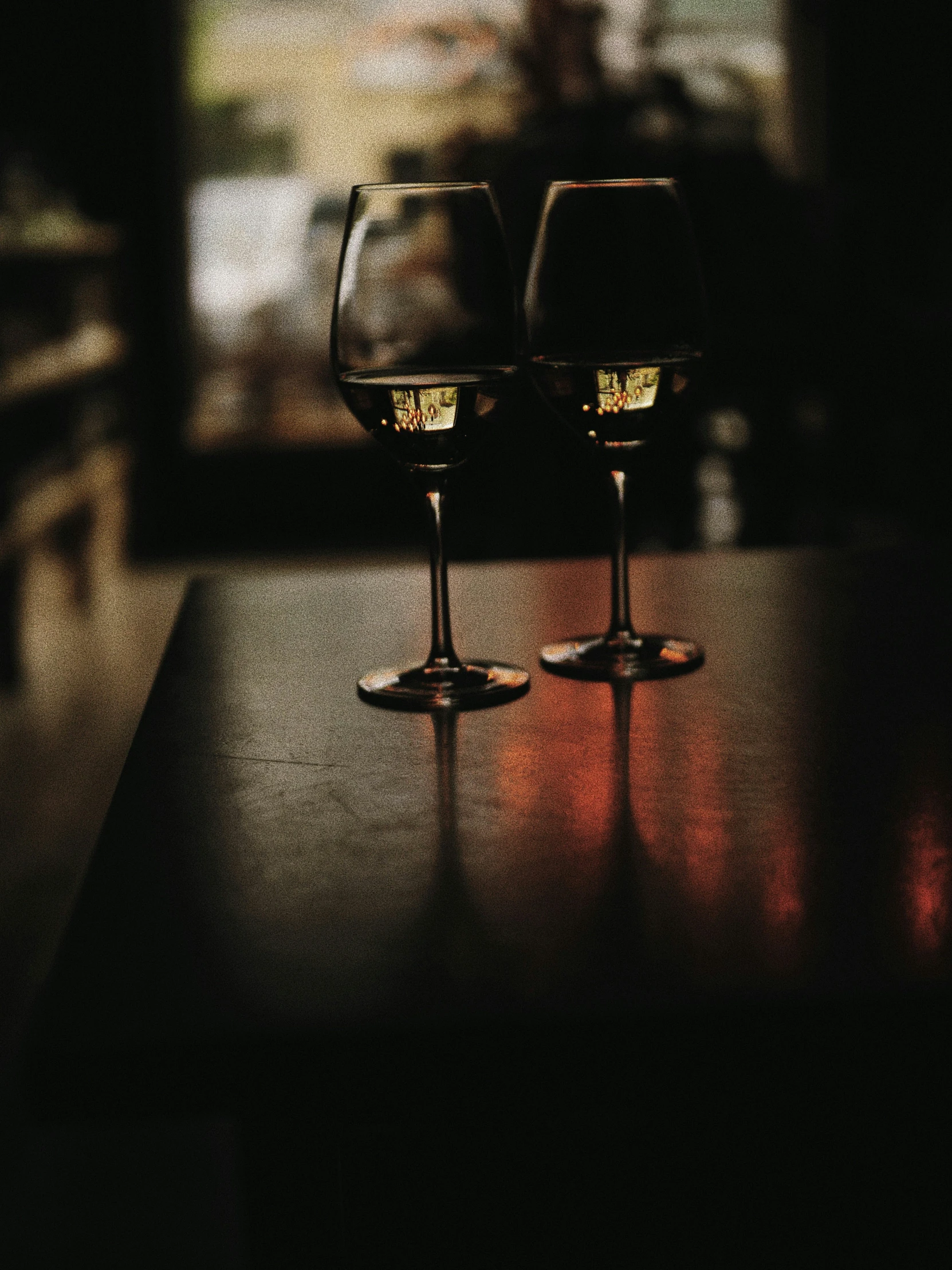 a po of two glasses of wine on top of a table