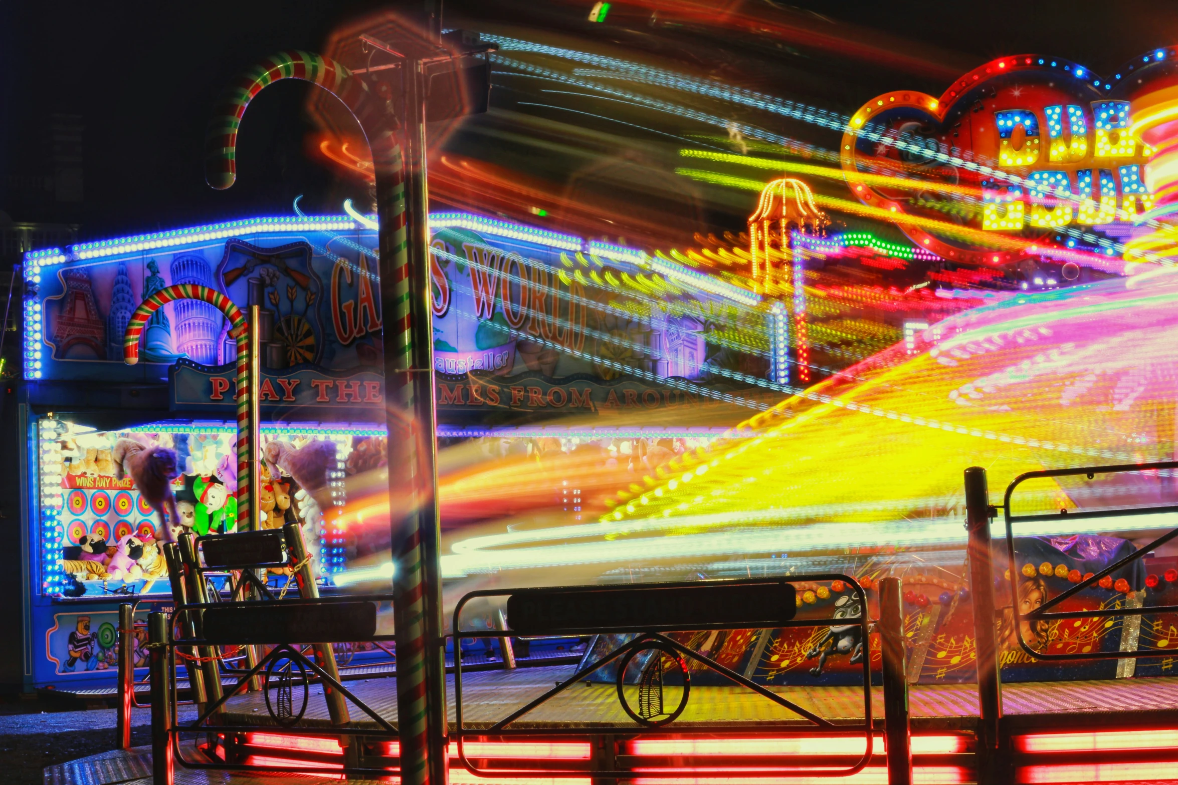 a carnival in an amut park has many colored lights