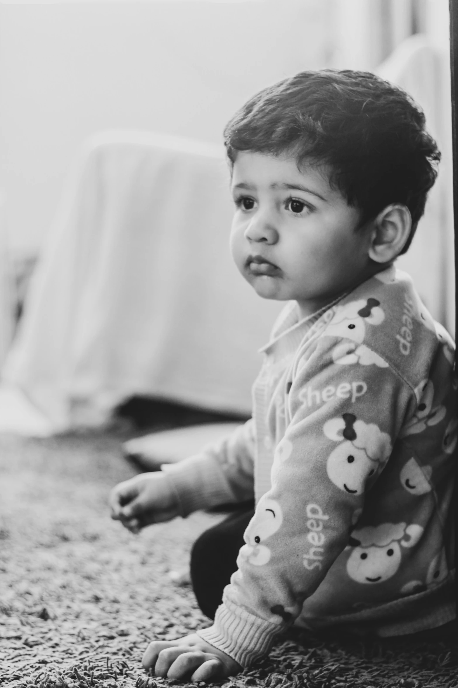 black and white pograph of a toddler on the floor