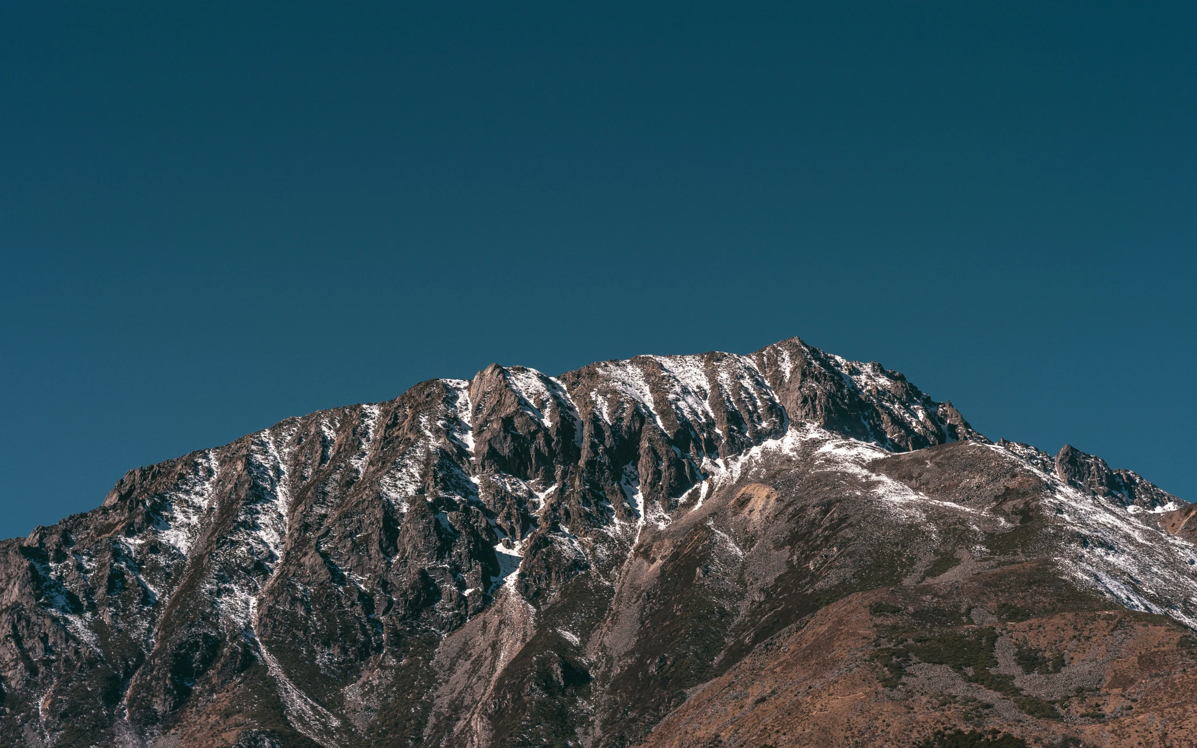 the top of a mountain with snow on it