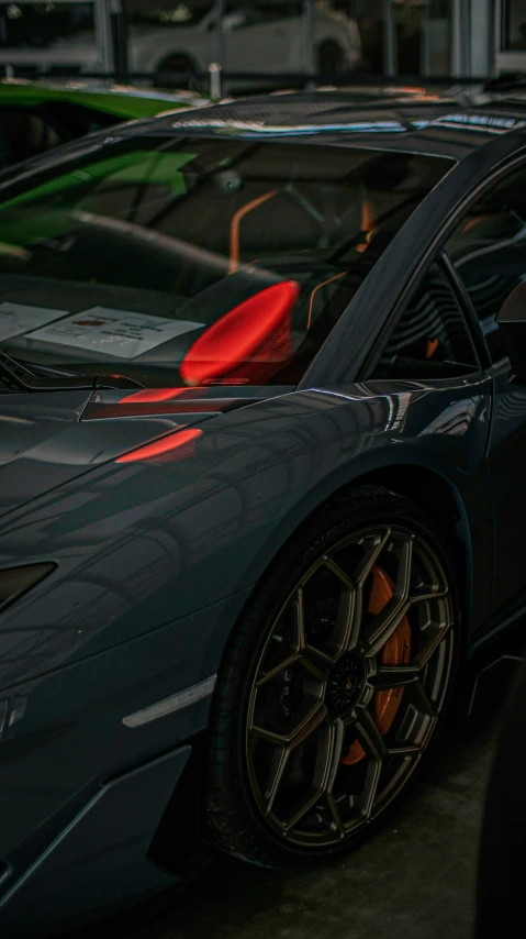 two exotic colored cars parked side by side in a parking lot