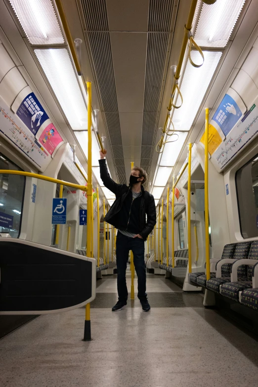 a person in the middle of a bus on their cell phone