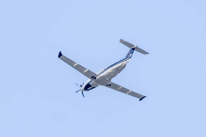 the propeller plane is flying high in the sky