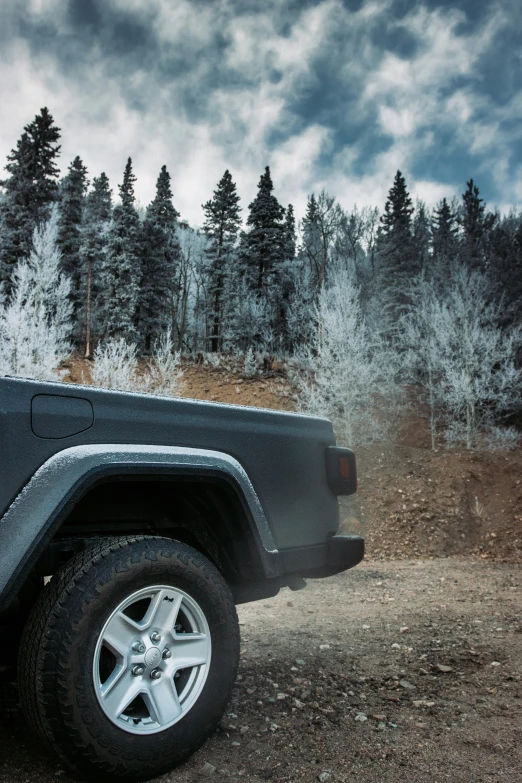 a black jeep is on the ground with a sky background