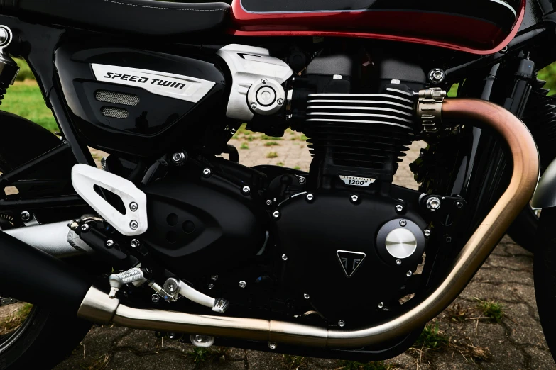 closeup of the exhaust pipes and front wheel of a parked motorcycle