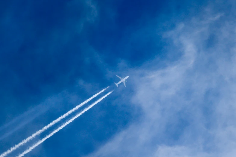 two jet airliner flying high up into the sky