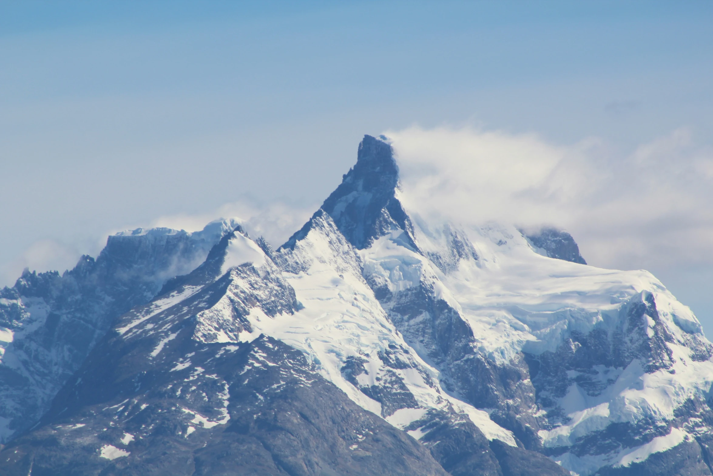 the snow covered peaks on top of a mountain