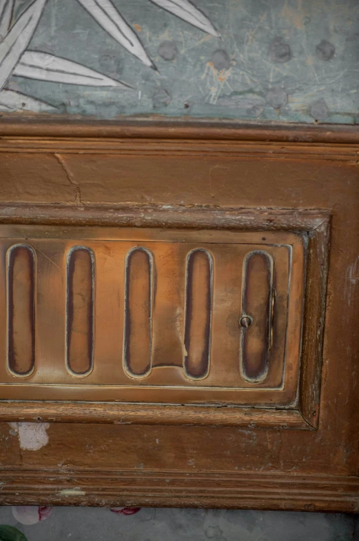 a closeup of an old door with metal writing on it