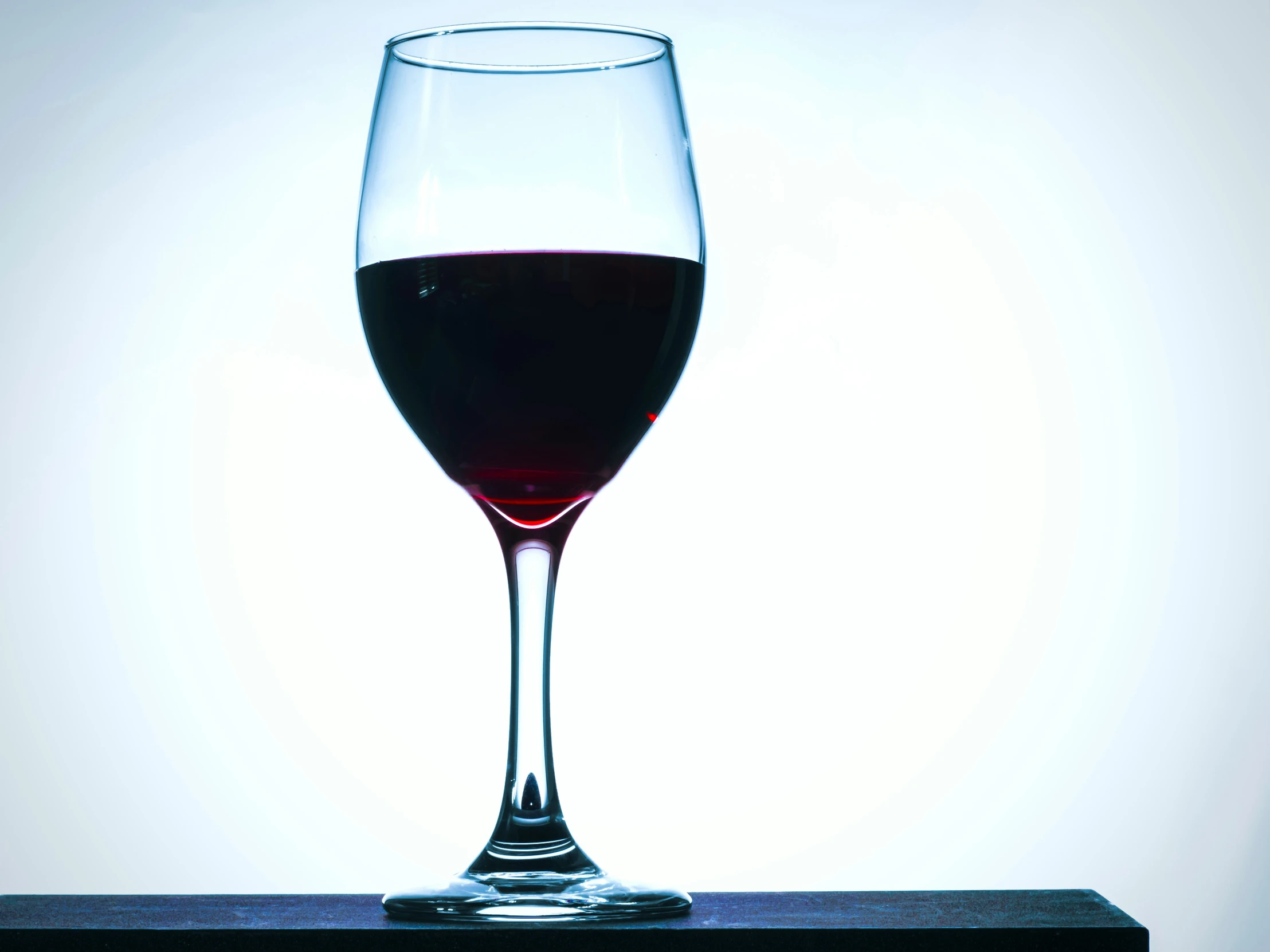 a close up of a wine glass on a table