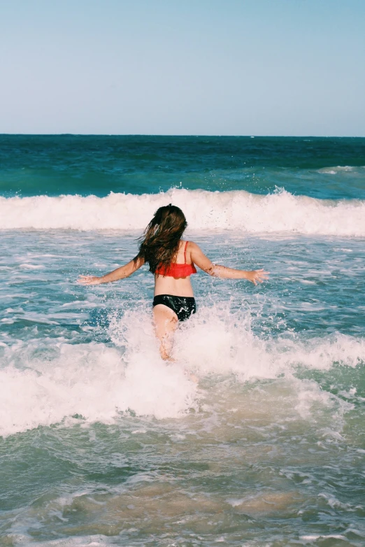  on surfboard playing in the waves