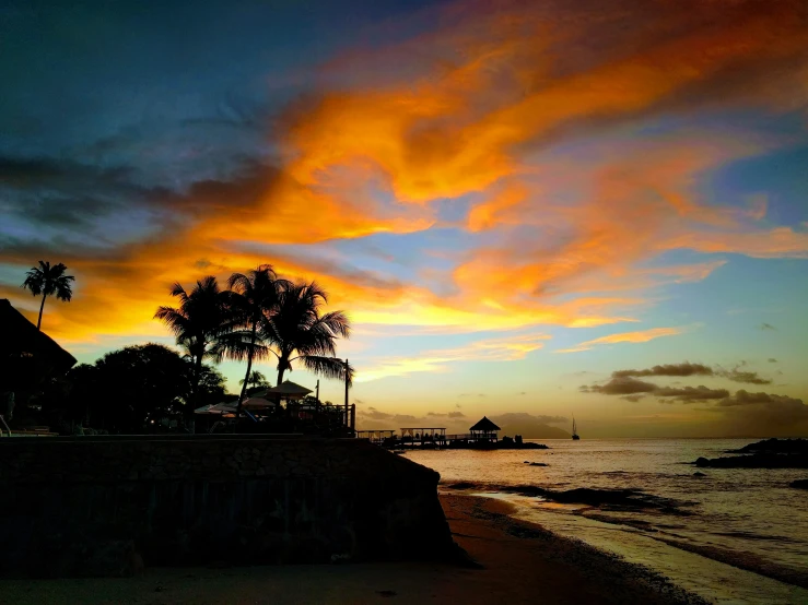 a beautiful sunset over the ocean on a beach