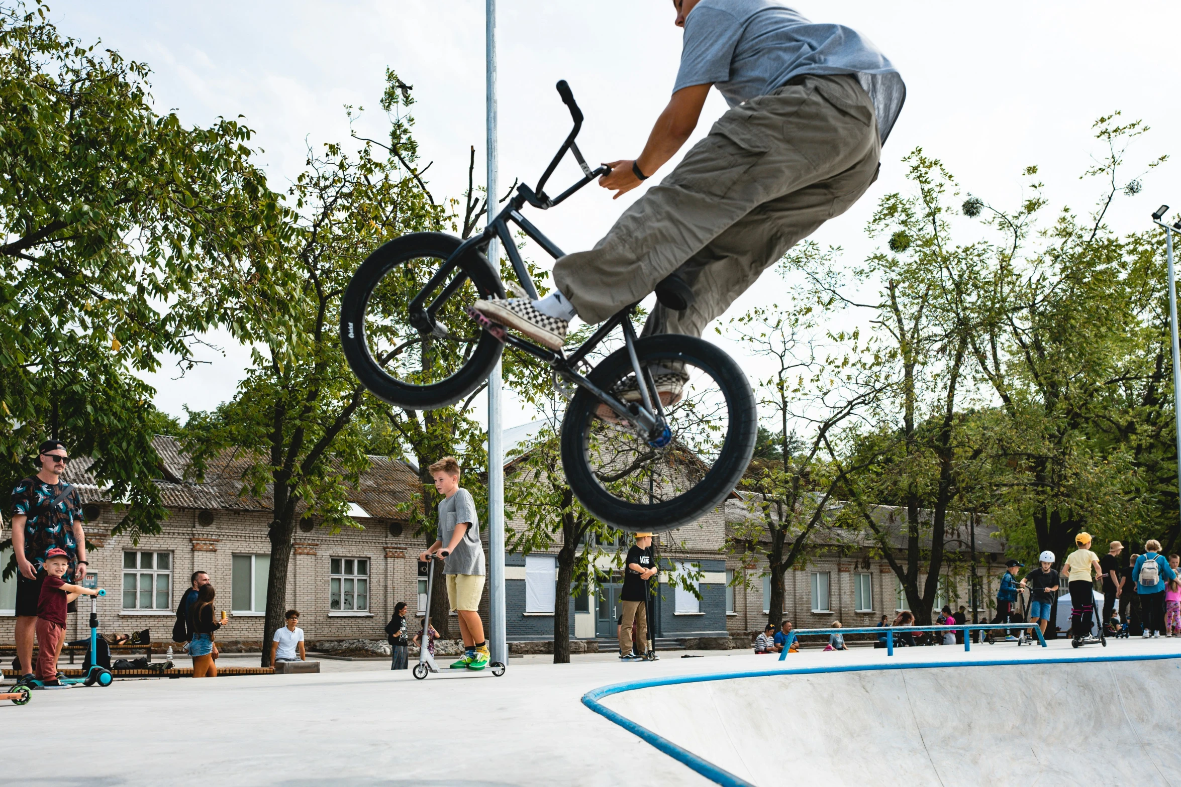 a man jumping over an upside down skateboard on top of a ramp