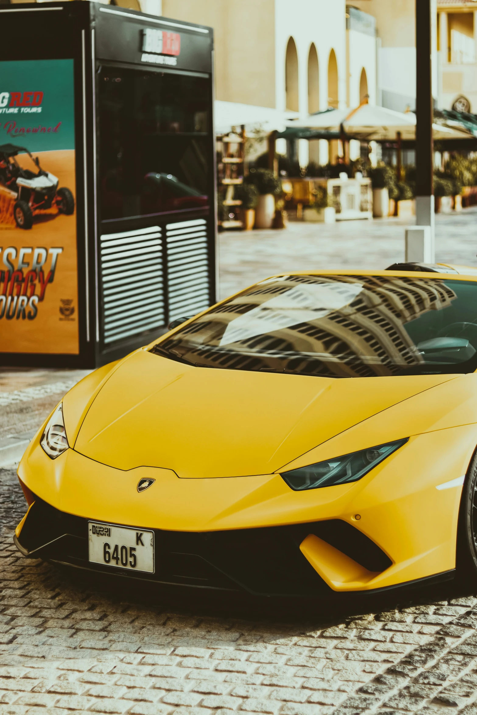 a lamb sports car parked on a stone area