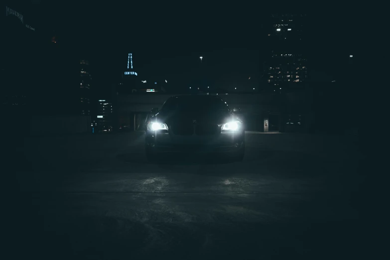 the headlights of a car in the city at night