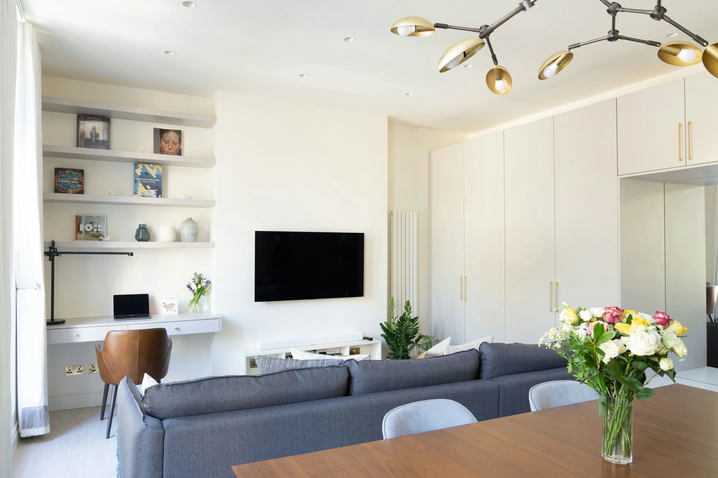 a modern living room has several shelves and a tv