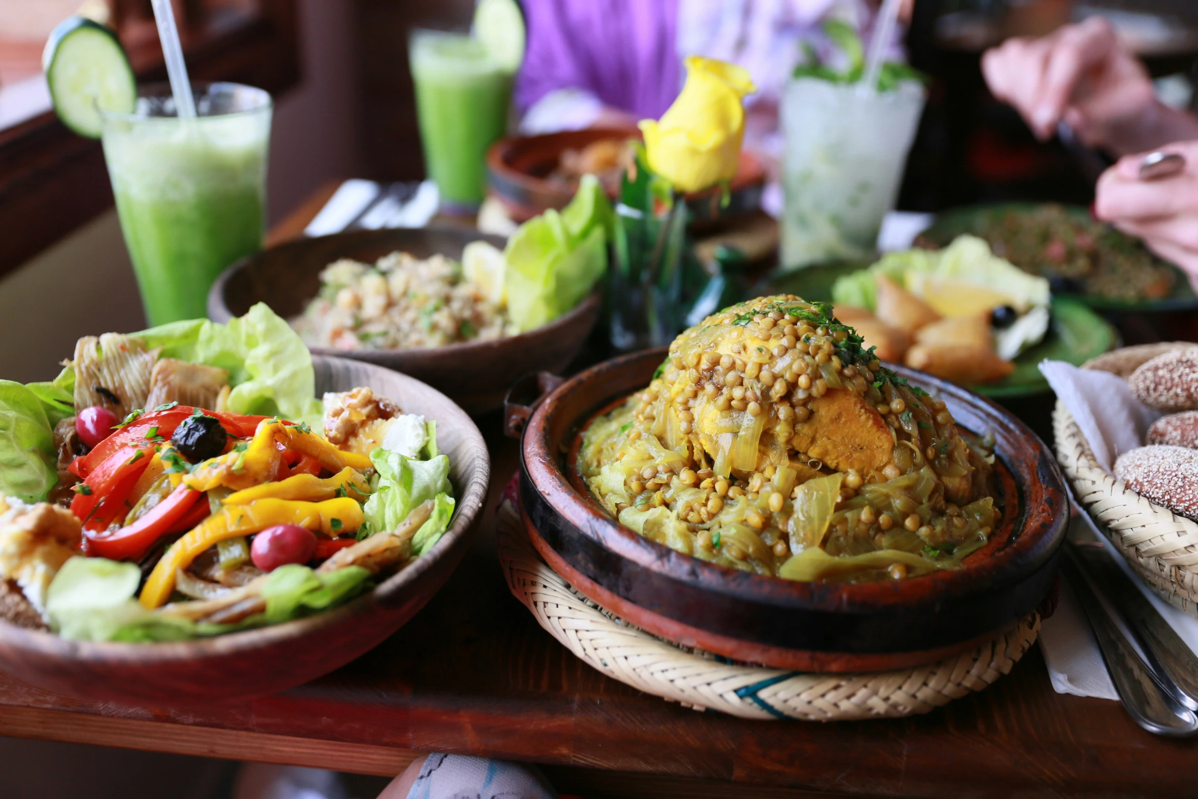 plates of food on a dining table with many different types of dishes