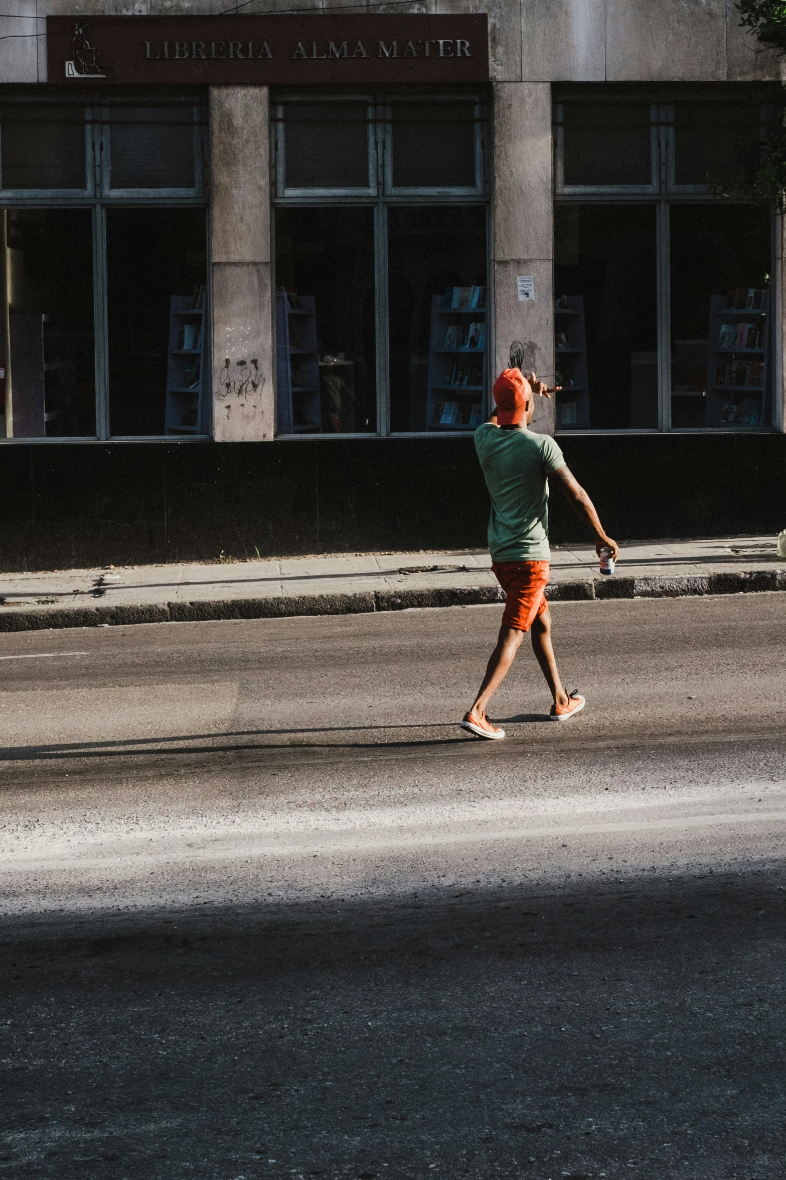 a young woman walking down the street with a skateboard