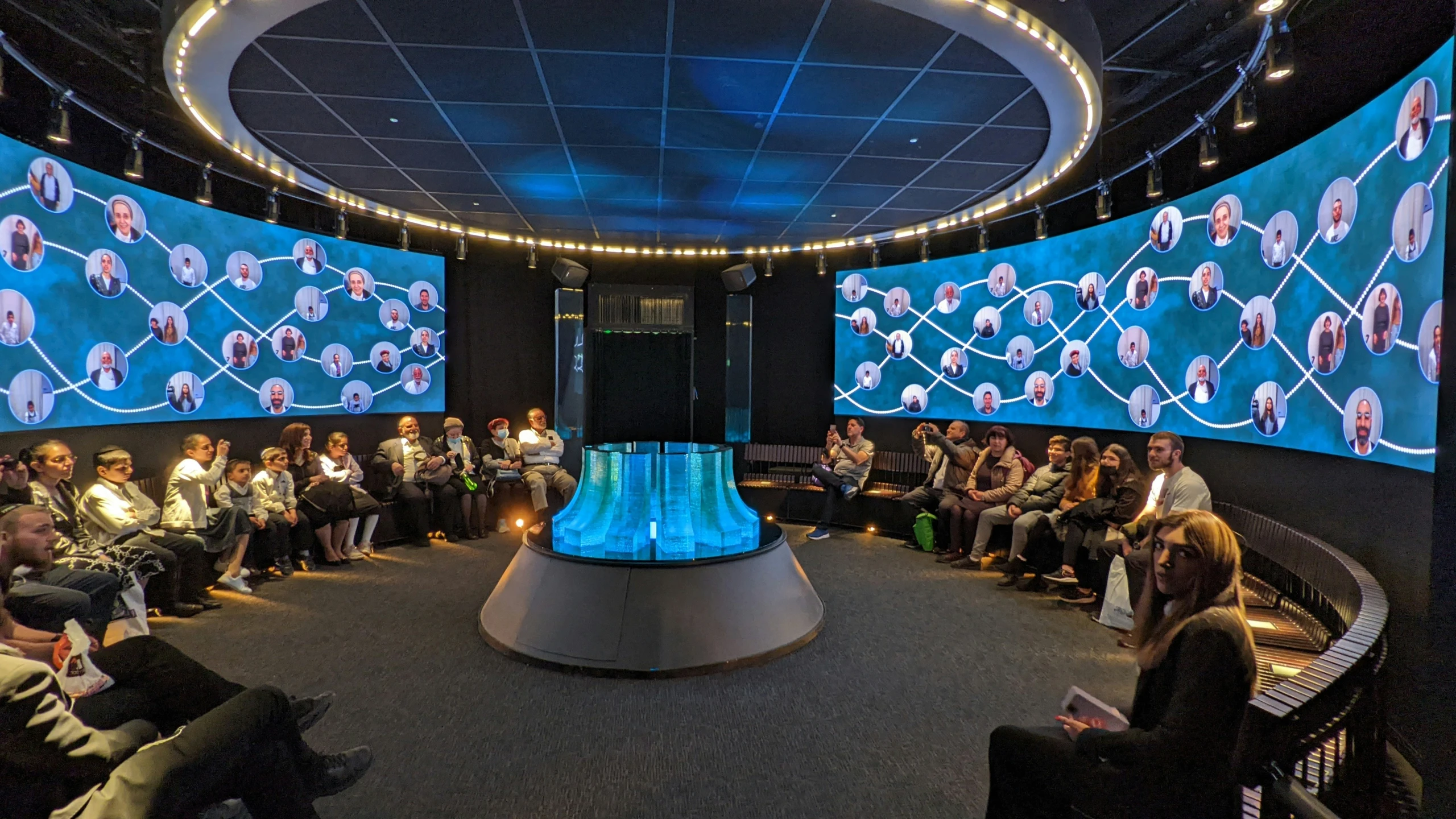 large group of people listening to a panel