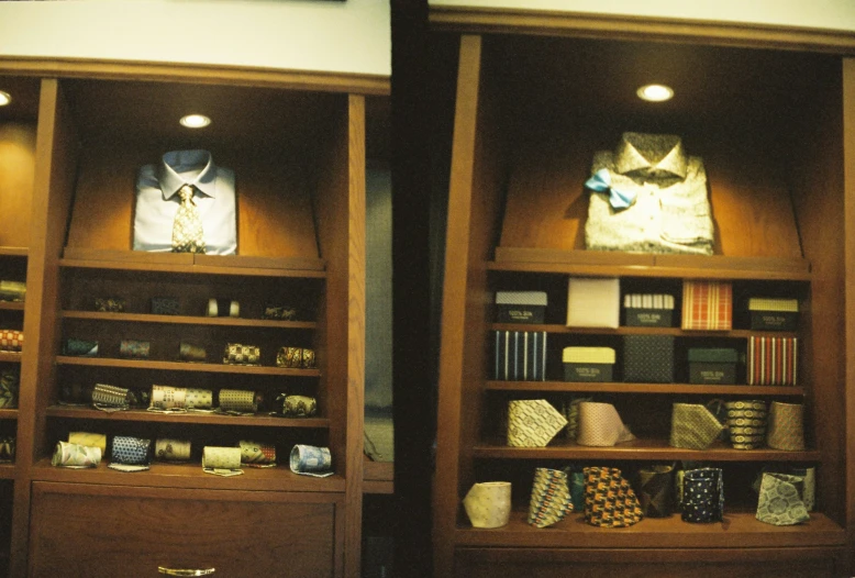 two wooden shelves with shirts on them