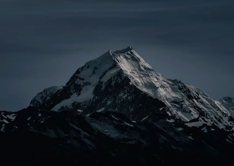 a very tall mountain with snow covered top