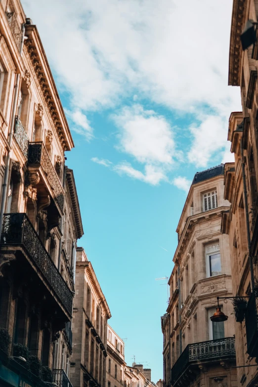 a city street with buildings on each side and a sky above