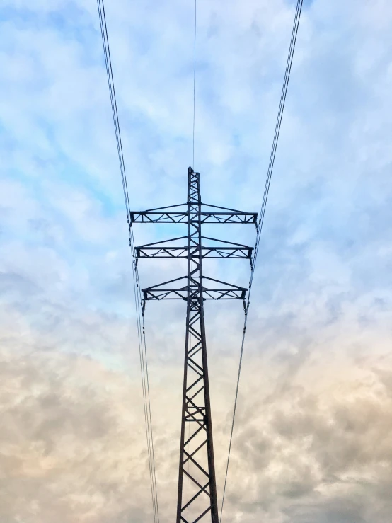 a tall tower with power lines next to it