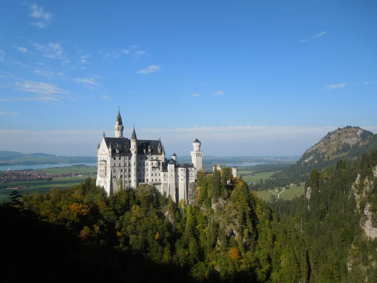 an castle sitting atop a lush green hill