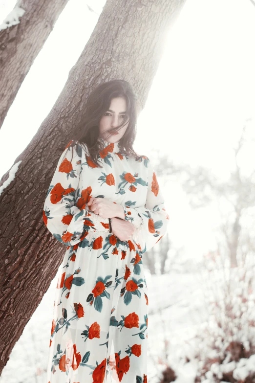 a beautiful woman standing under a tree and smiling