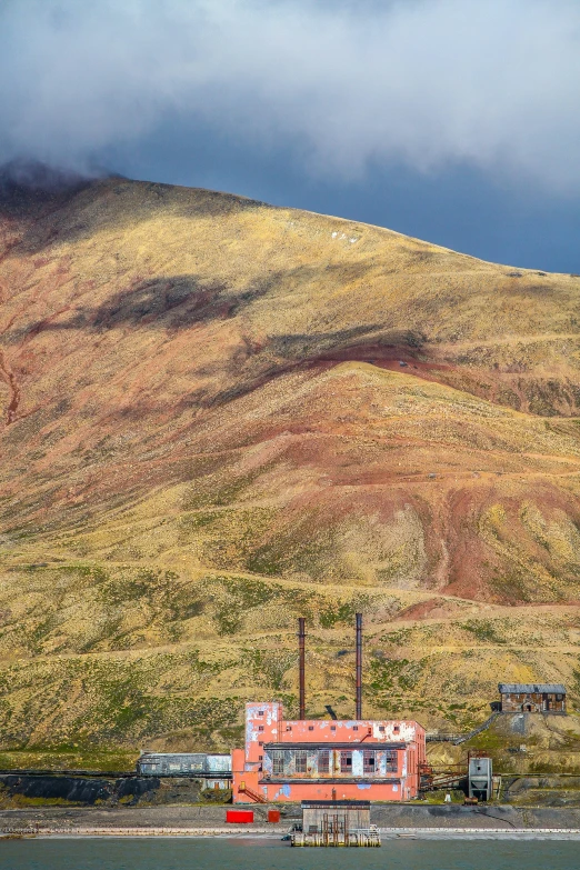 a house and the hill by itself, the mountains are yellow