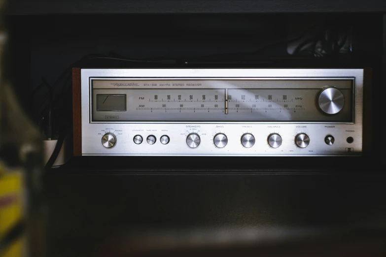 an old silver radio with eight ons on display