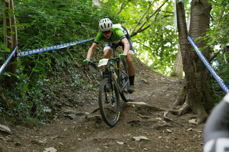 a man riding a bike on a muddy trail