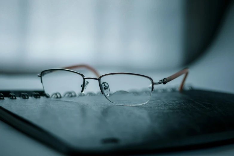 an eyeglass that is on top of a laptop