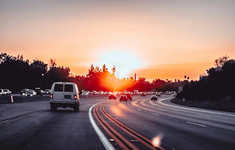 there are many cars in traffic going down this highway