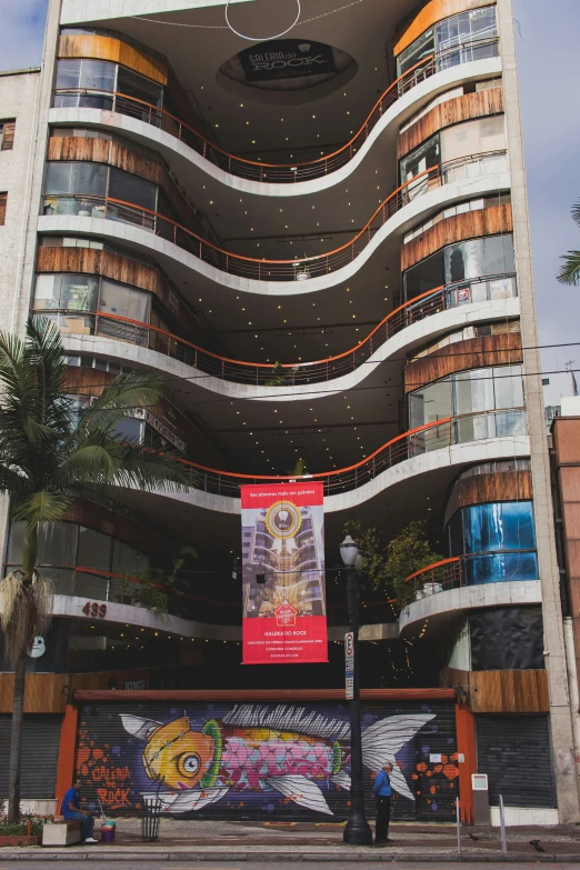 a large building with a colorful sign in front