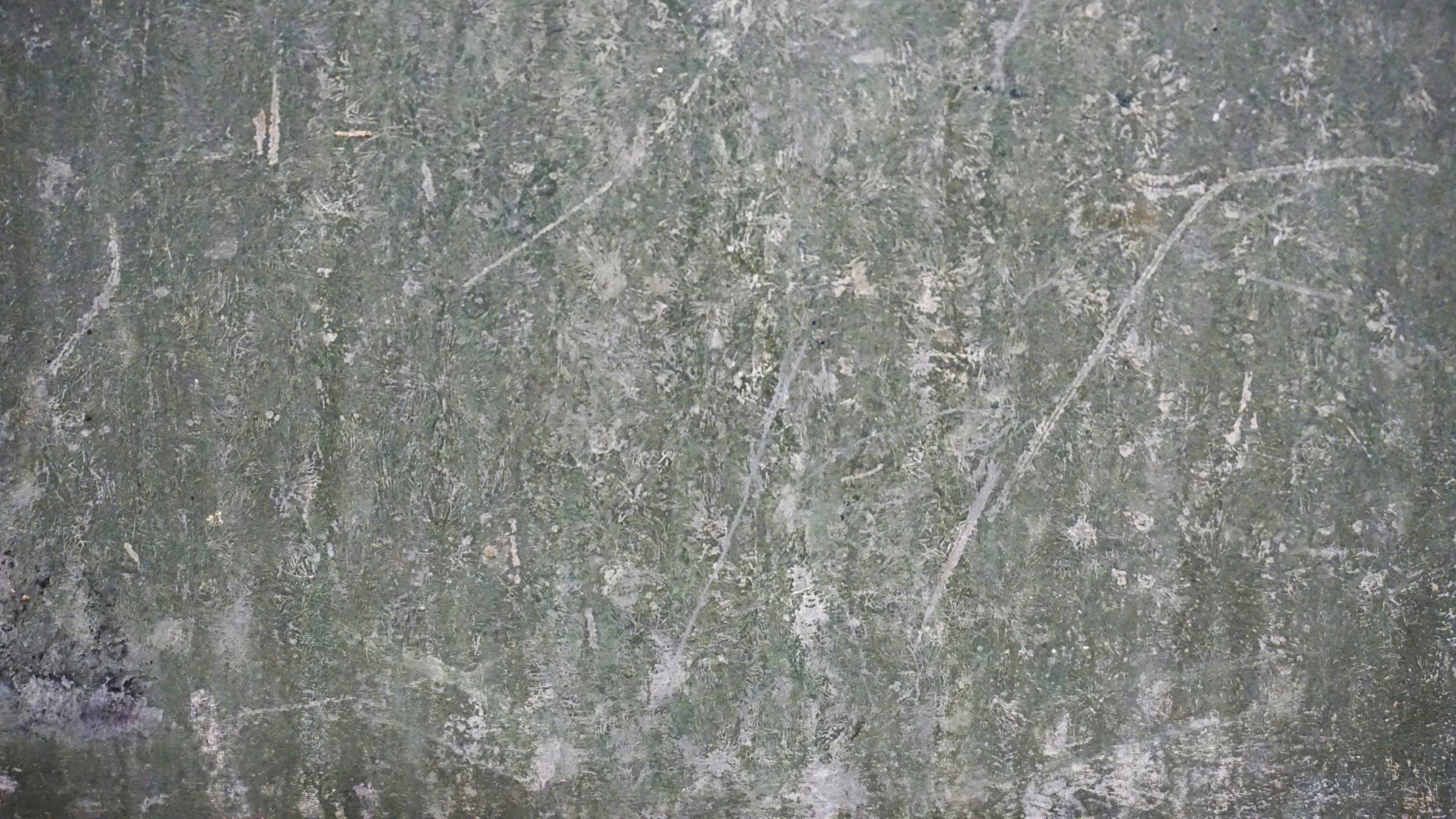 the concrete is worn and weathered with many patterns