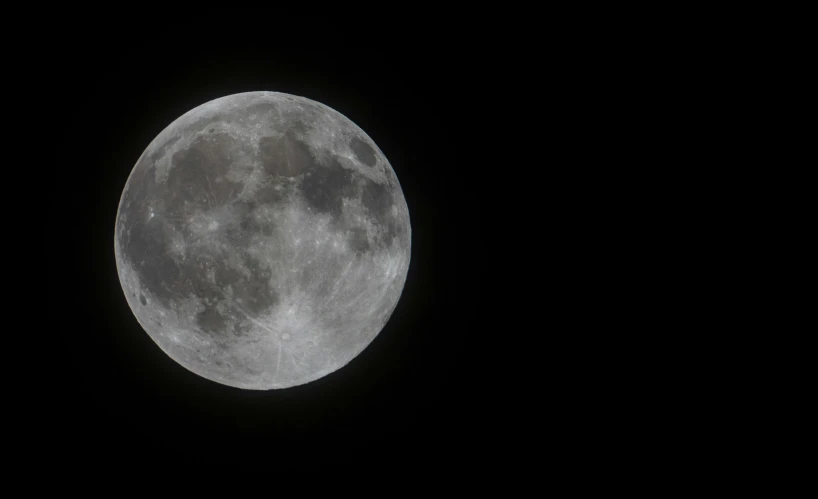 a full moon in the black sky during the night