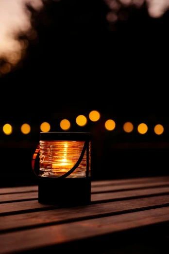 a lit up lantern sitting on top of a wooden deck