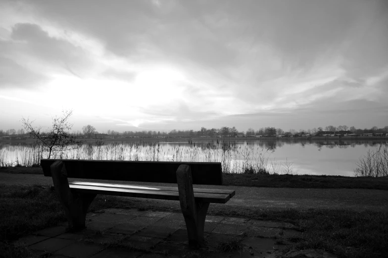 a bench sitting in front of a large body of water