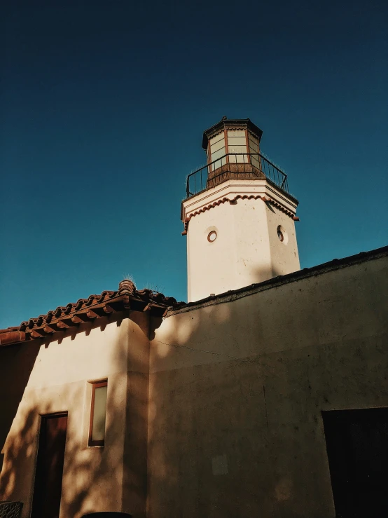 a light house standing against a blue sky