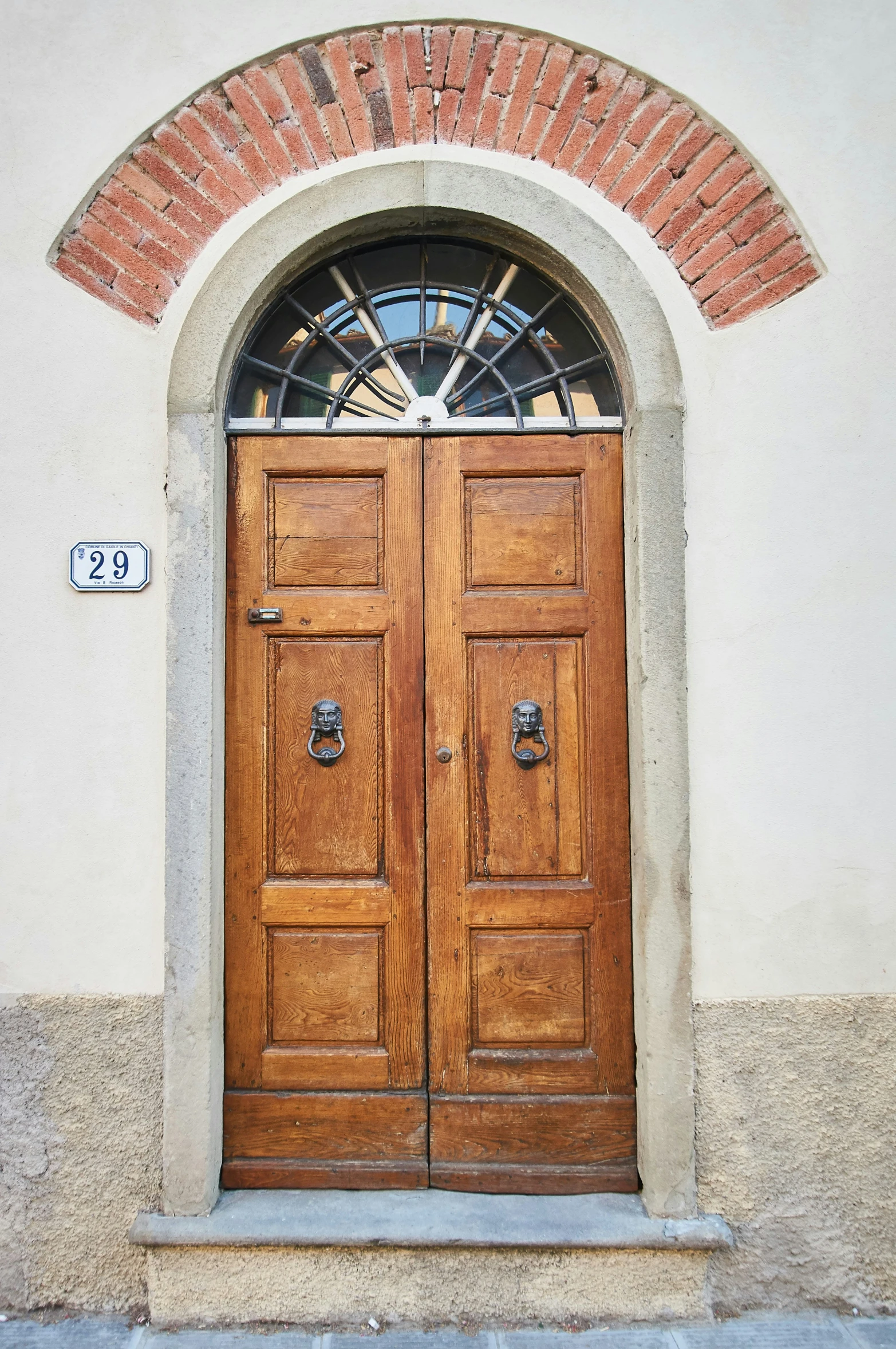 a large wooden door sits in a wall