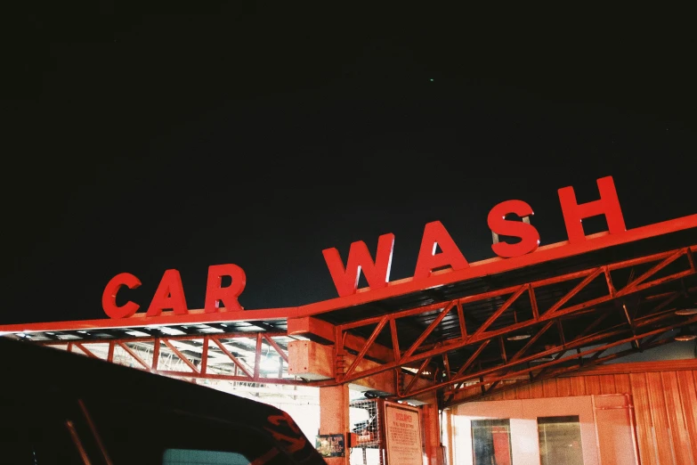a car wash and a building in the dark