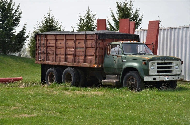 an old truck that is sitting on the grass