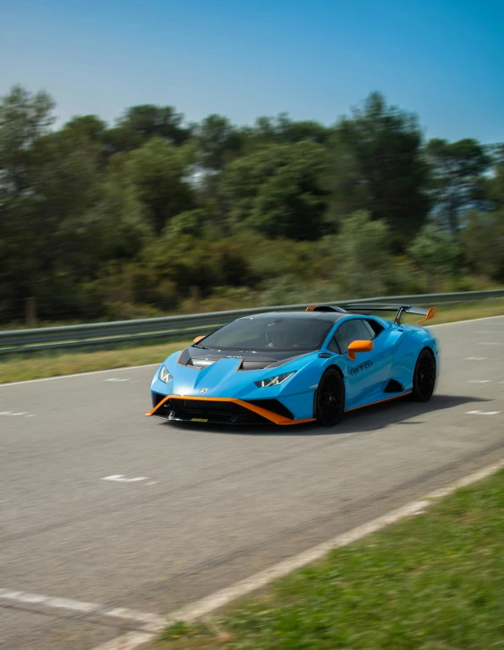 a bright blue sports car driving down a road