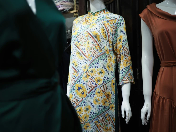 mannequins dressed up in matching dresses standing outside