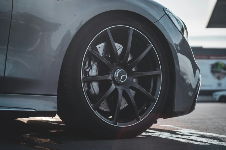 closeup view of a car's spokes, and tire wheel