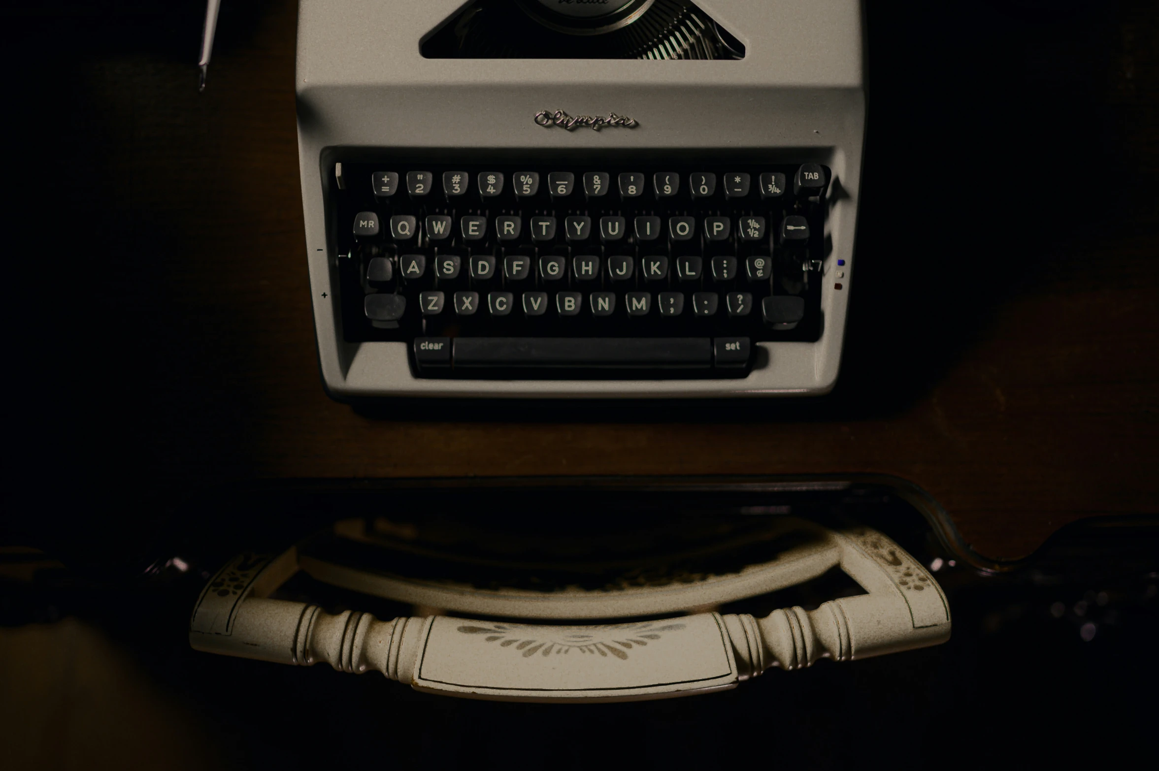 a white typewriter and wires in the darkness