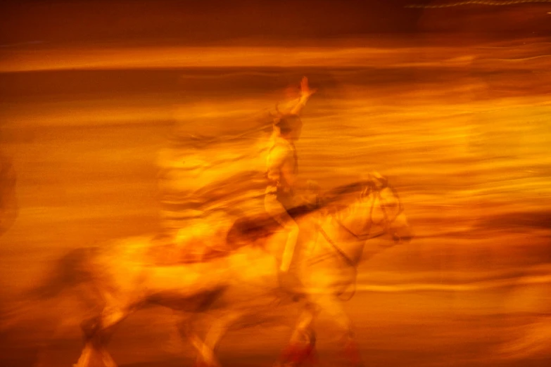 two horses running in opposite directions with people in the background